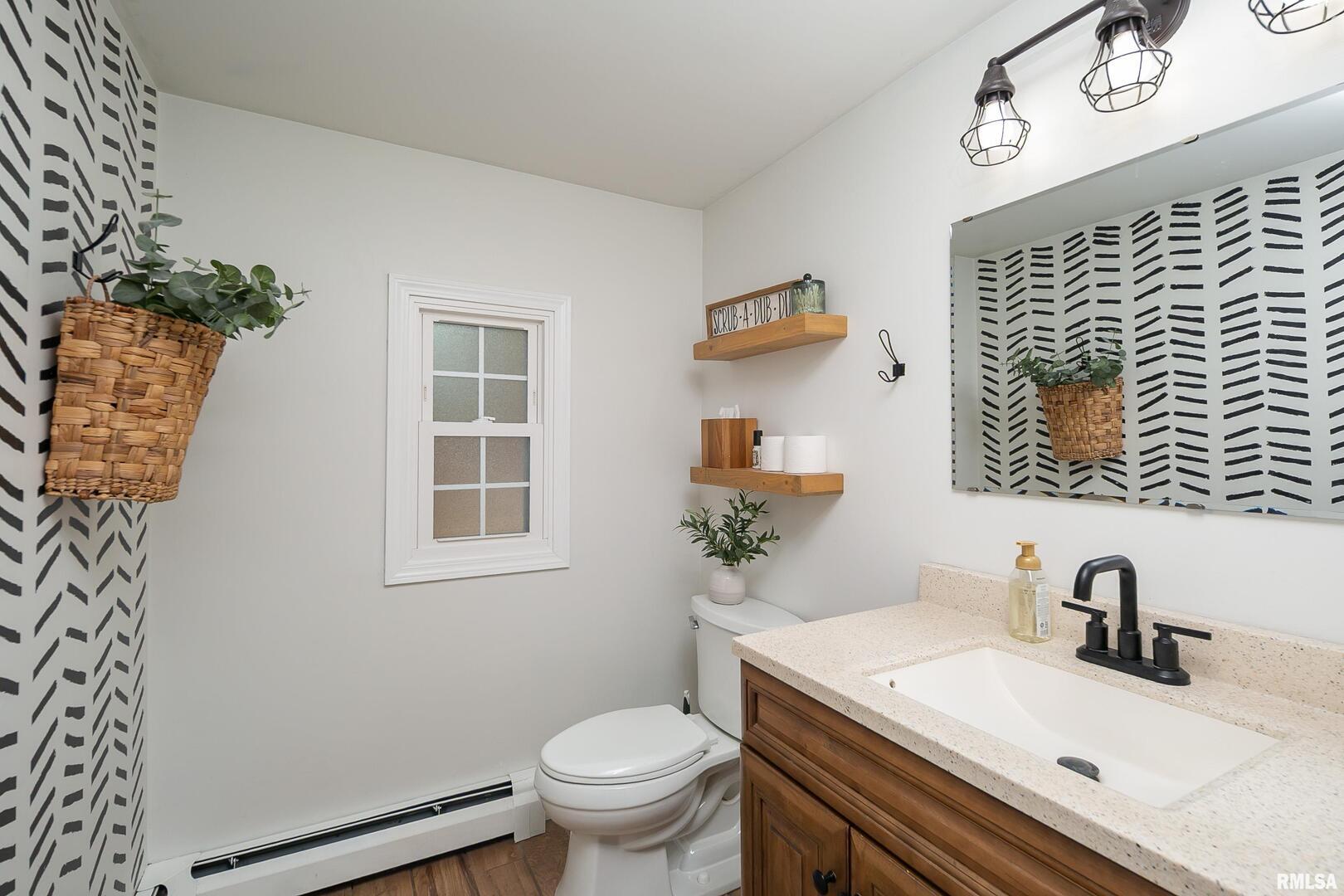 401 3rd Street Matherville, IL 61263 - Photo 18 of 32 a bathroom with a sink toilet and mirror