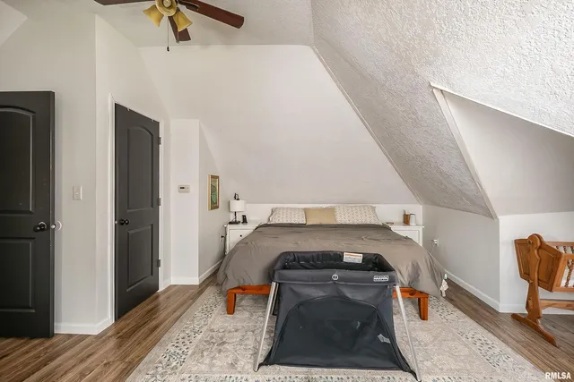 a bed room with a bed and wooden floor