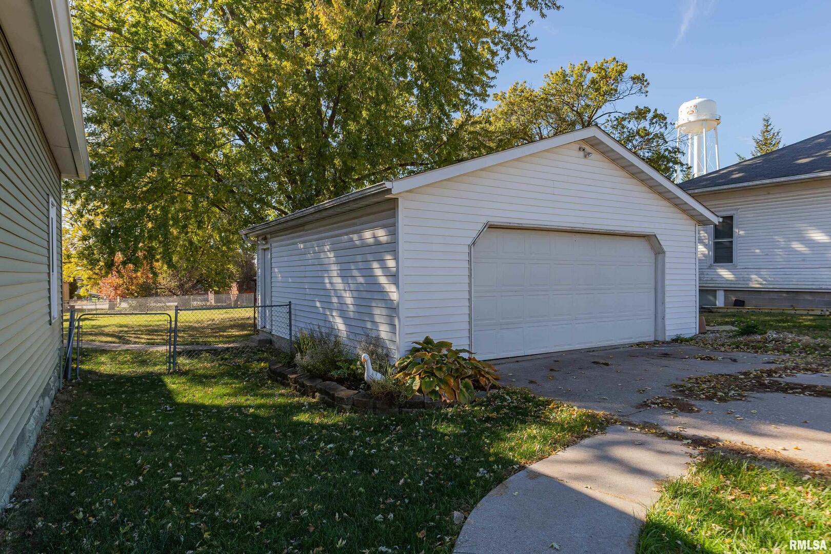 401 3rd Street Matherville, IL 61263 - Photo 31 of 32 a backyard of a house with plants and large tree
