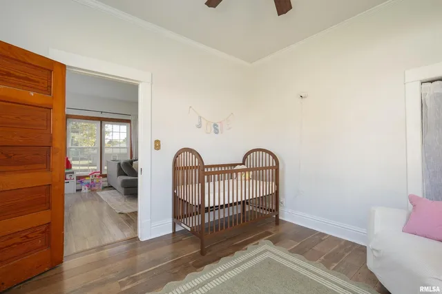 a view of a livingroom with wooden floor and furniture