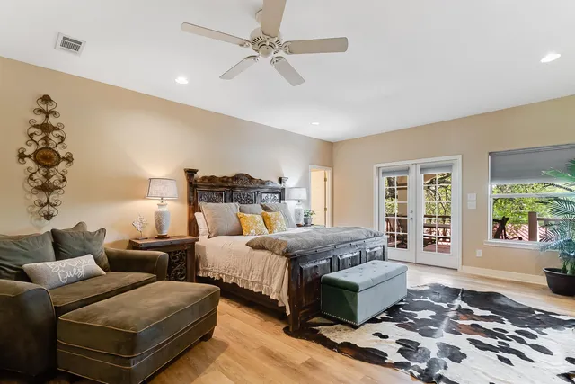 a spacious bedroom with a bed a couch and a window