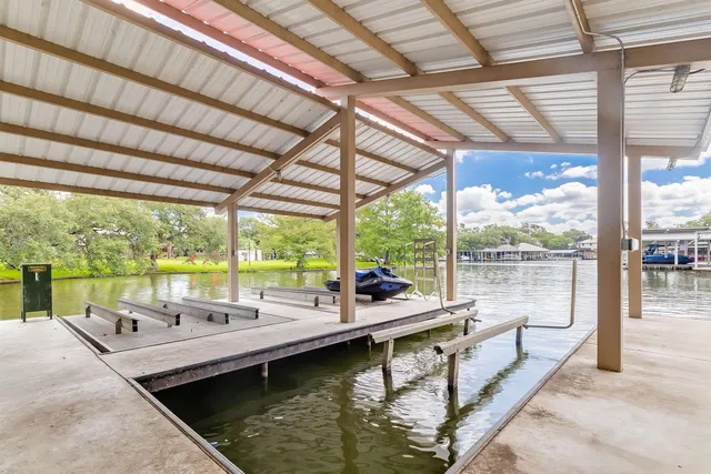 an aerial view of city and lake with trees