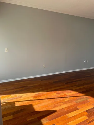 a view of a room with wooden floor