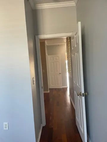 a view of a hallway with wooden floor
