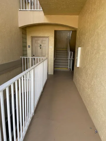 a view of a porch with wooden floor and stairs