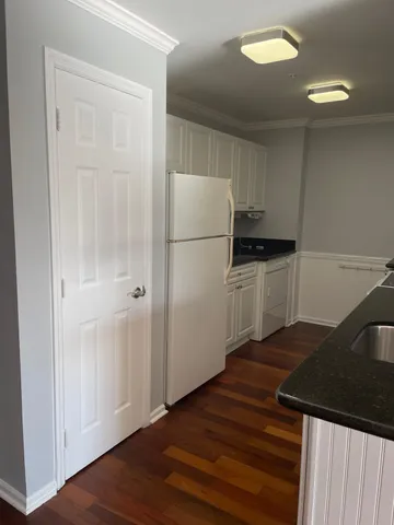 a kitchen with granite countertop a refrigerator and a stove