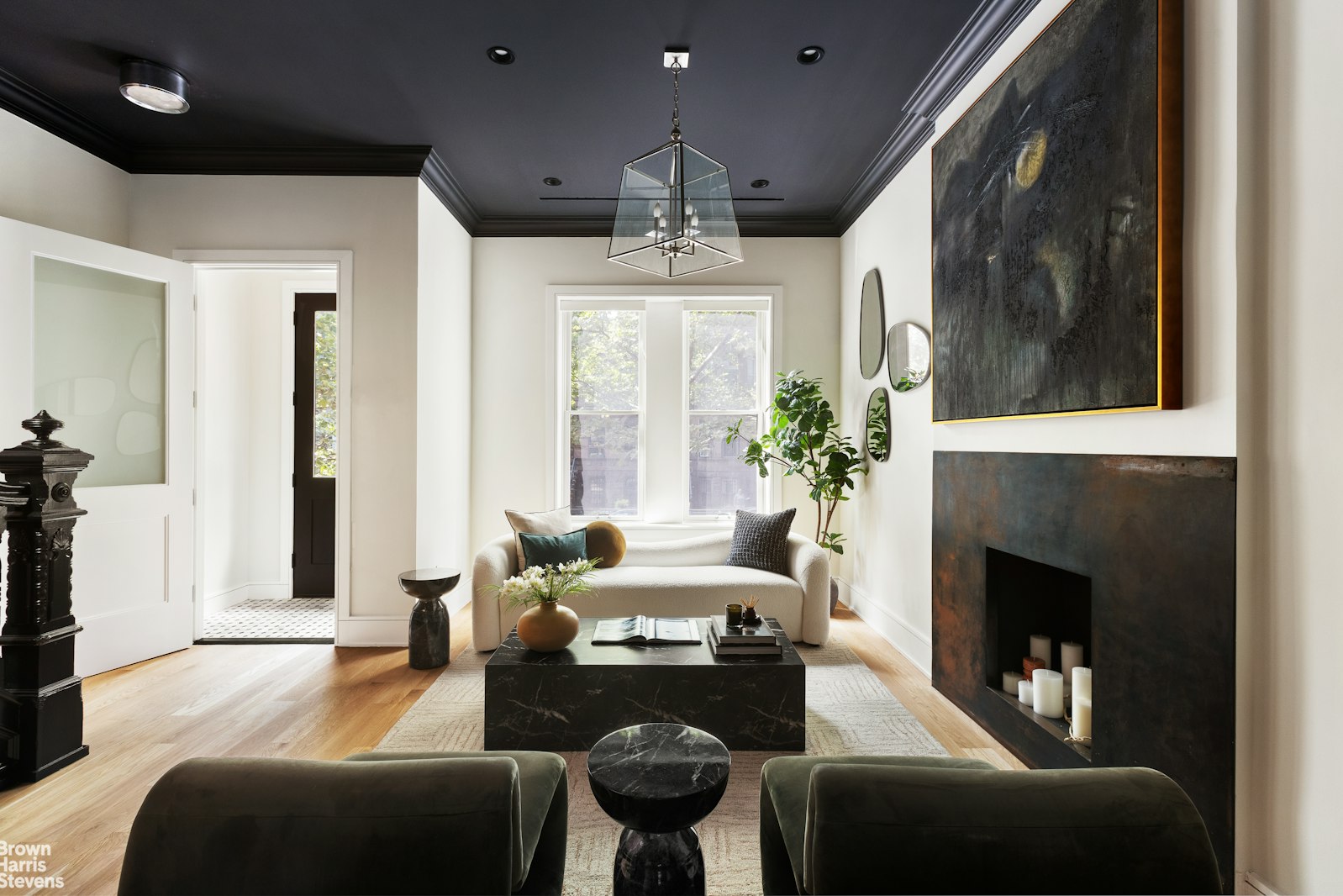 605 Decatur Street Brooklyn, NY 11233 - Photo 4 of 14 a living room with furniture a fireplace and a chandelier