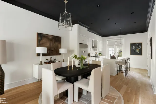 a living room with furniture a fireplace and a chandelier