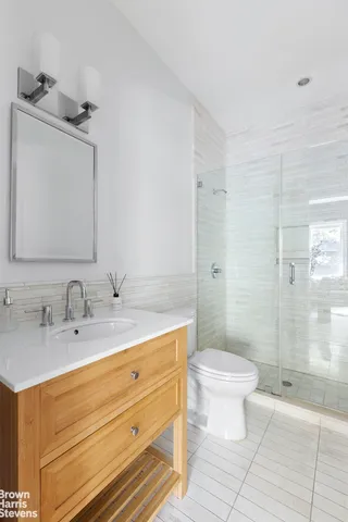 a bedroom with bed couch and window