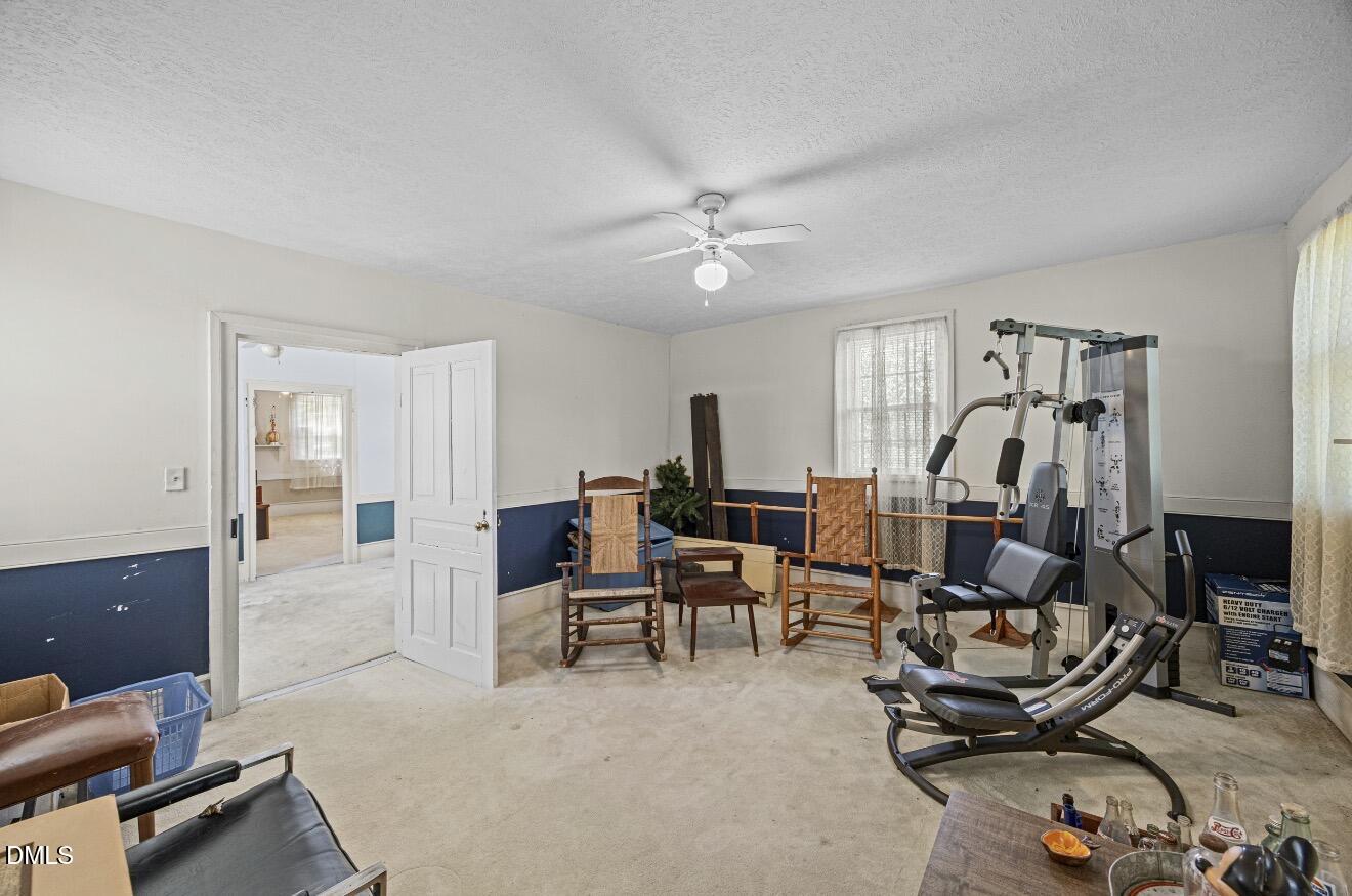 679 Mintz Road Roseboro, NC 28382 - Photo 26 of 80 a view of a livingroom with furniture and gym equipment