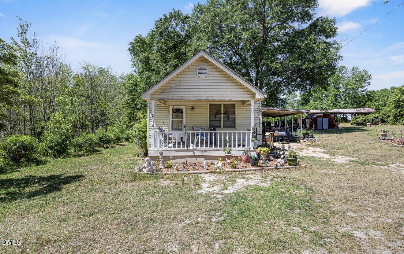 679 Mintz Road Roseboro, NC 28382 - Photo 43 of 80 a view of a house with a yard and lawn chairs with wooden fence