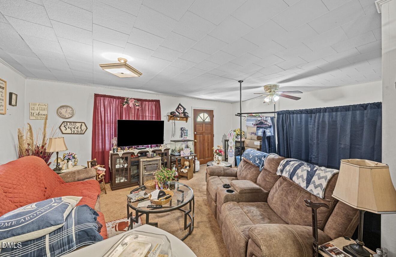 679 Mintz Road Roseboro, NC 28382 - Photo 46 of 80 a living room with furniture a flat screen tv and a large window