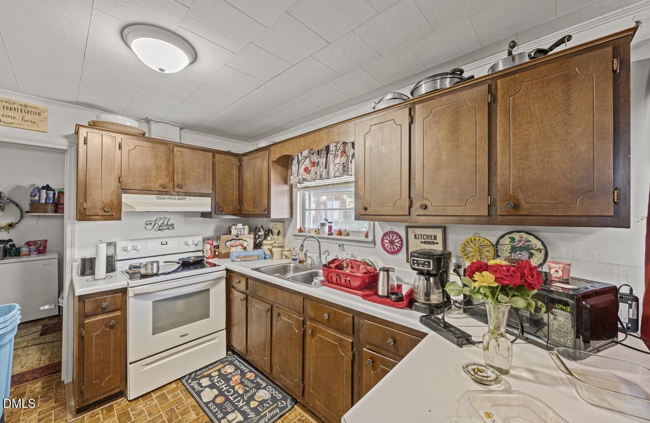 679 Mintz Road Roseboro, NC 28382 - Photo 48 of 80 a kitchen with stainless steel appliances granite countertop a stove and cabinets