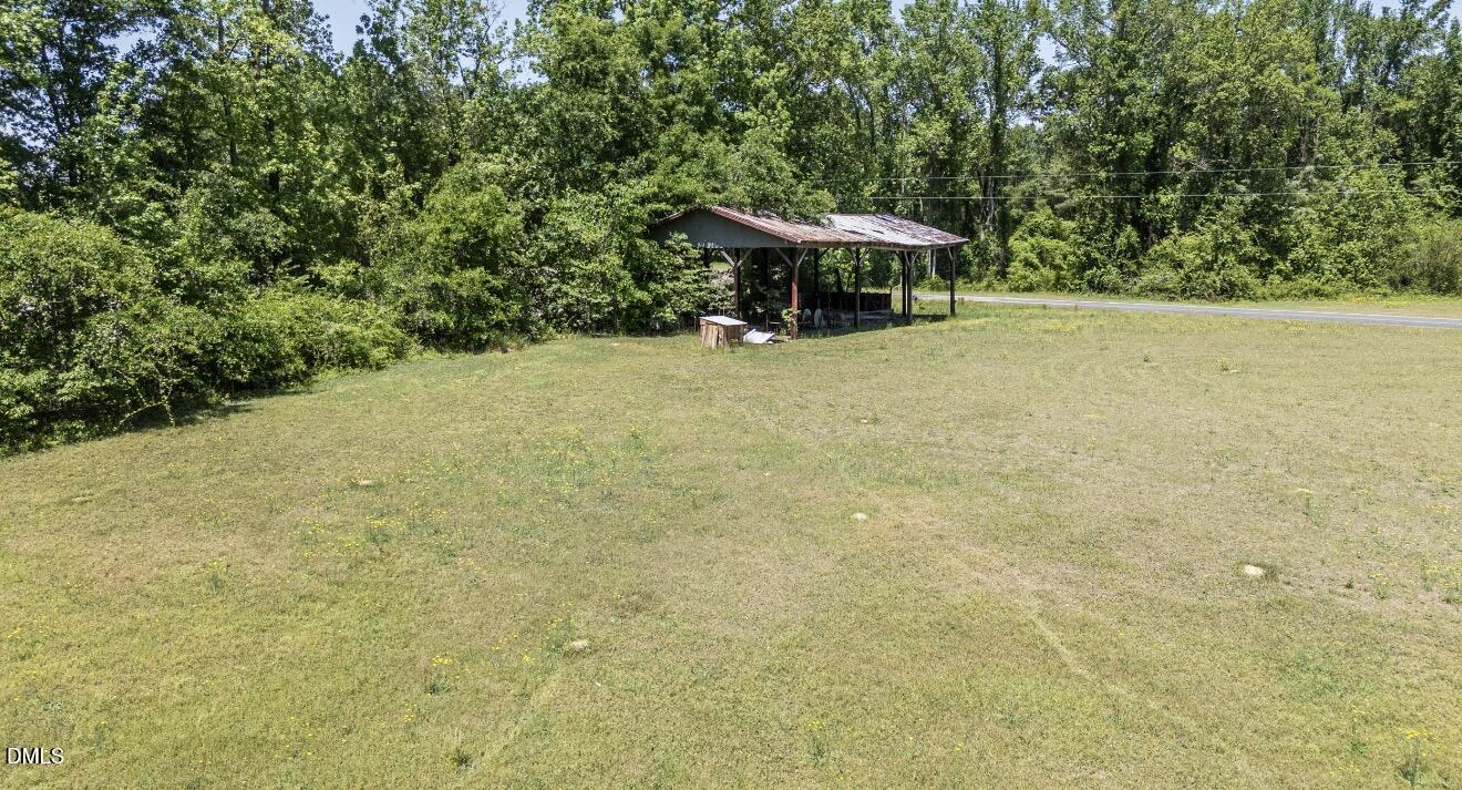 679 Mintz Road Roseboro, NC 28382 - Photo 59 of 80 a view of backyard with a table and chairs under an umbrella