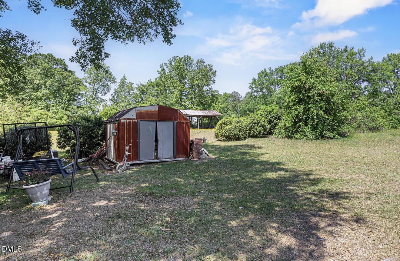679 Mintz Road Roseboro, NC 28382 - Photo 60 of 80 a view of a barn in the middle of a yard