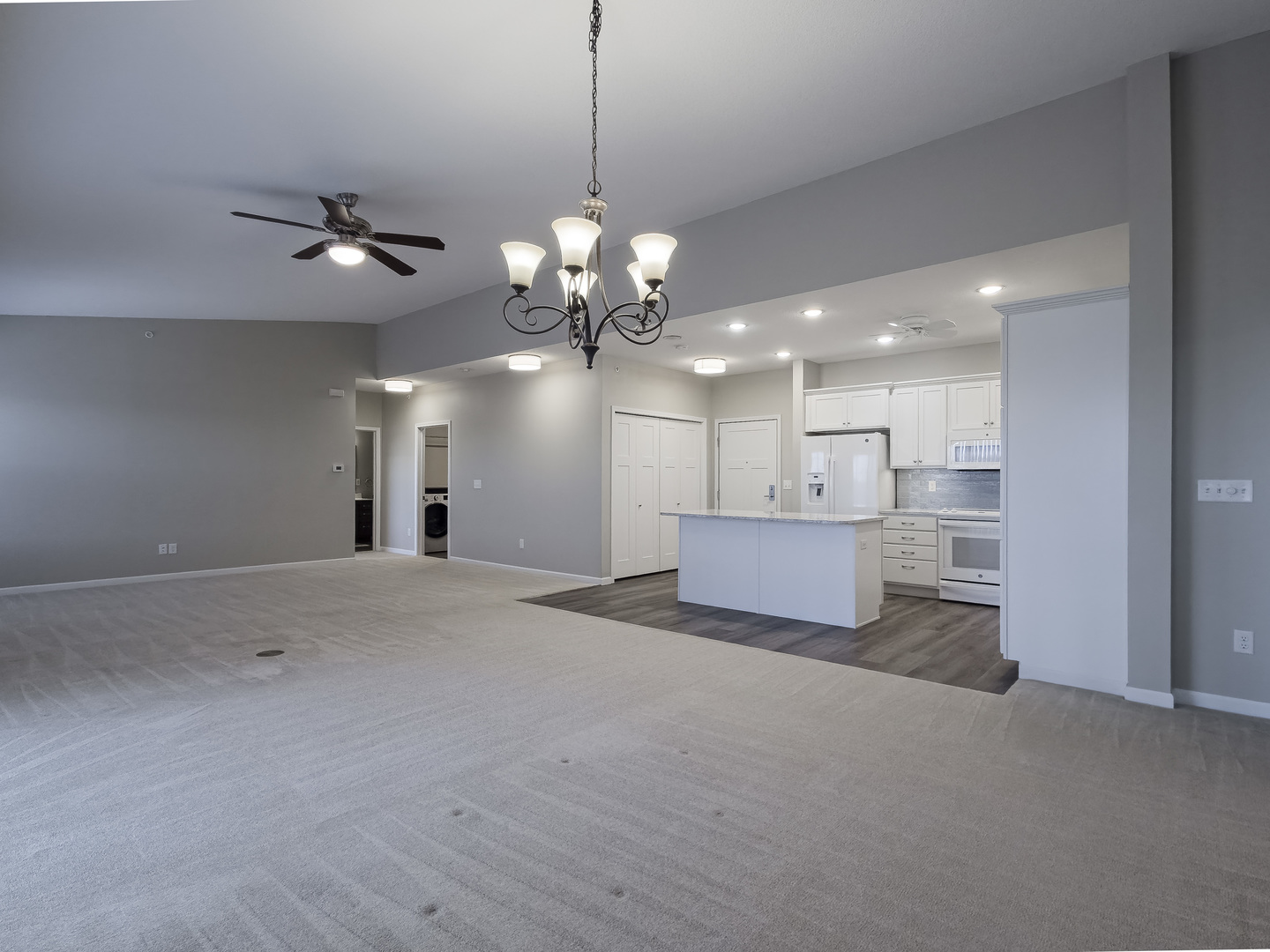 2592 Middle Road, Unit 313 Bettendorf, IA 52722 - Photo 23 of 52 a view of a livingroom and a kitchen chandelier a kitchen view