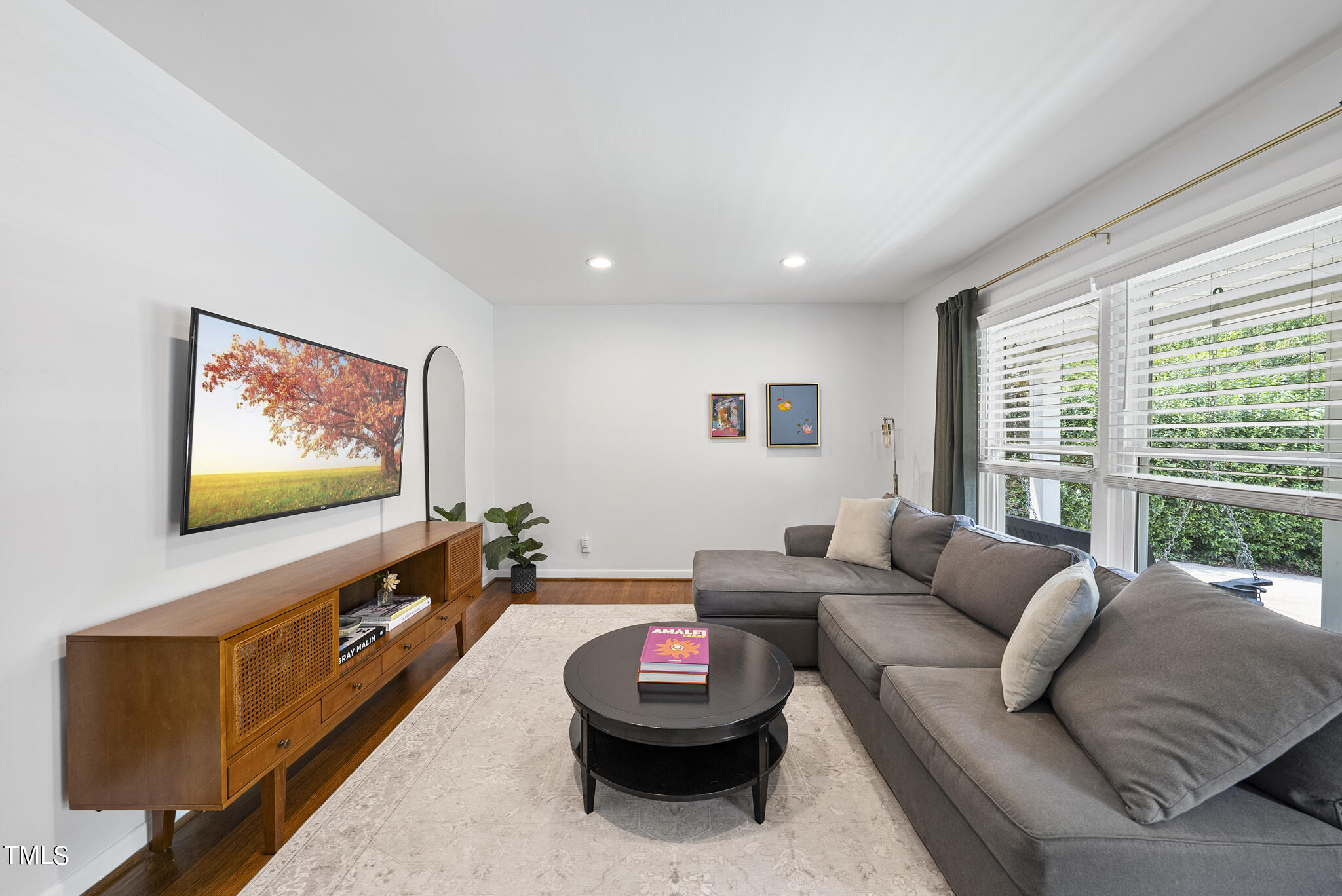 512 East Millbrook Road Raleigh, NC 27609 - Photo 12 of 29 a living room with furniture and a flat screen tv