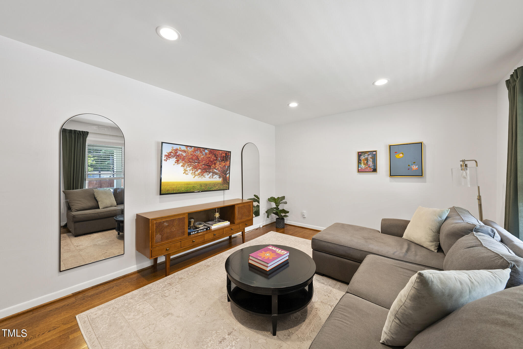 512 East Millbrook Road Raleigh, NC 27609 - Photo 13 of 29 a living room with furniture and a flat screen tv