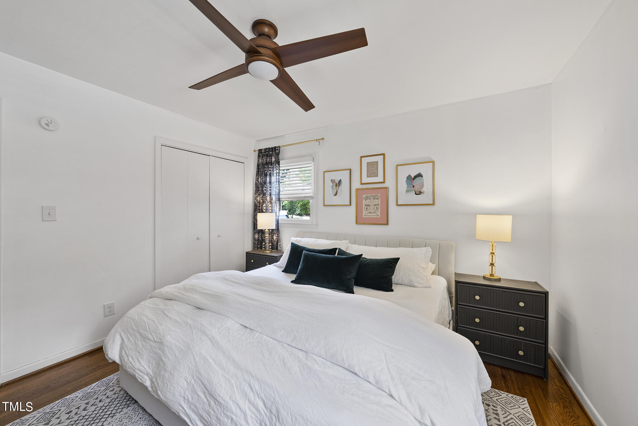 512 East Millbrook Road Raleigh, NC 27609 - Photo 15 of 29 a bedroom with a bed and a painting on the wall
