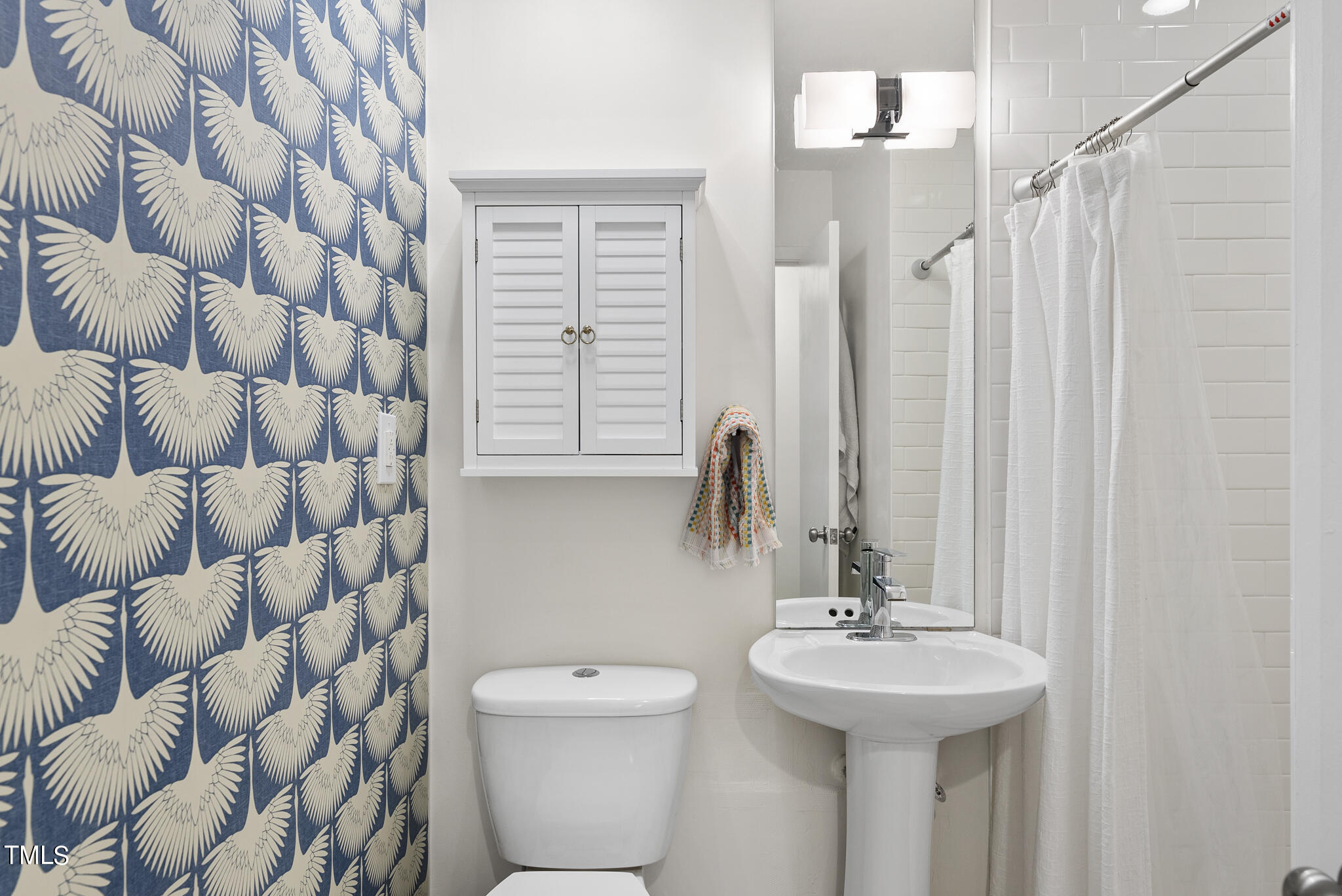 512 East Millbrook Road Raleigh, NC 27609 - Photo 18 of 29 a bathroom with a sink toilet and shower