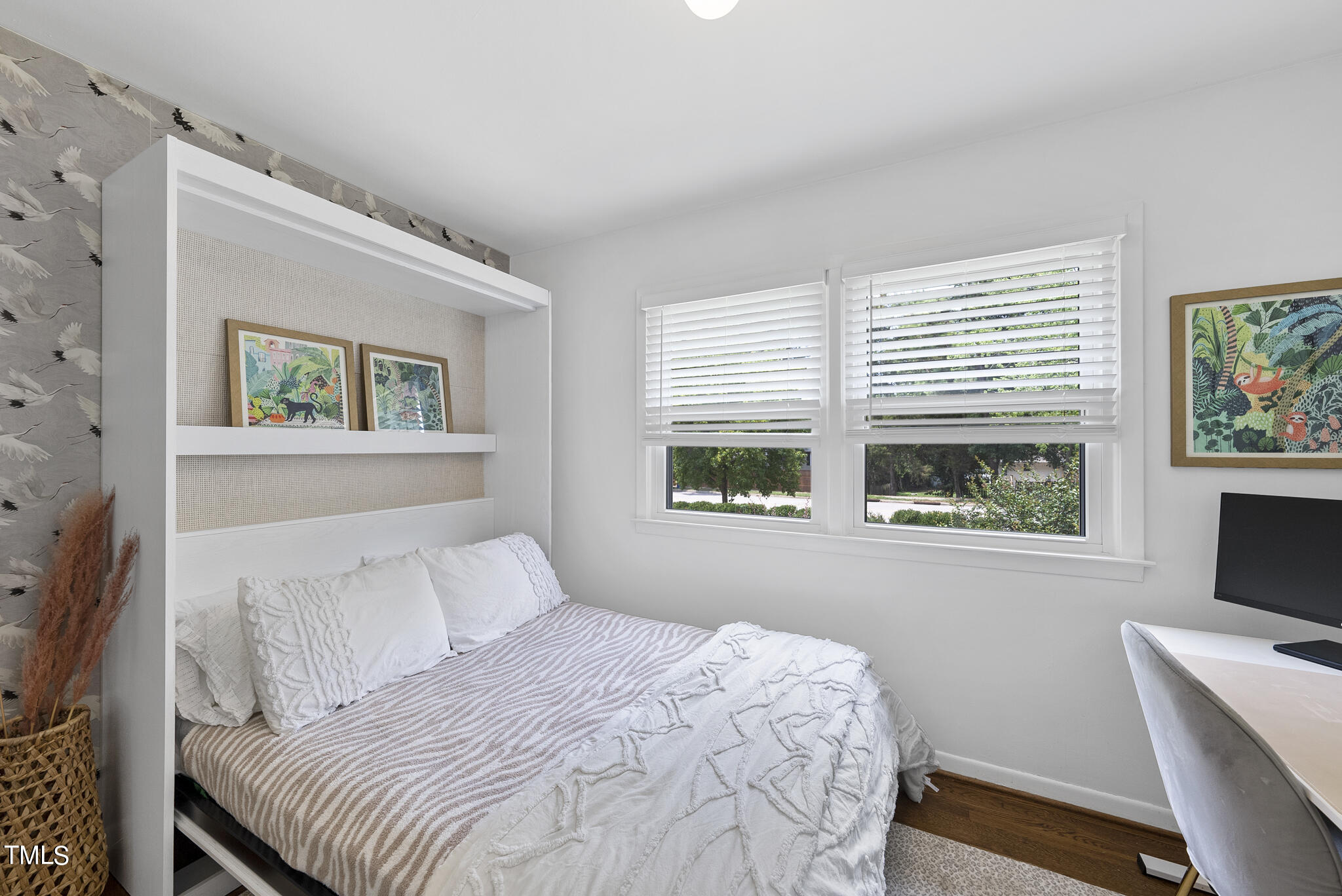 512 East Millbrook Road Raleigh, NC 27609 - Photo 20 of 29 a bedroom with a bed and a flat tv screen on the dresser