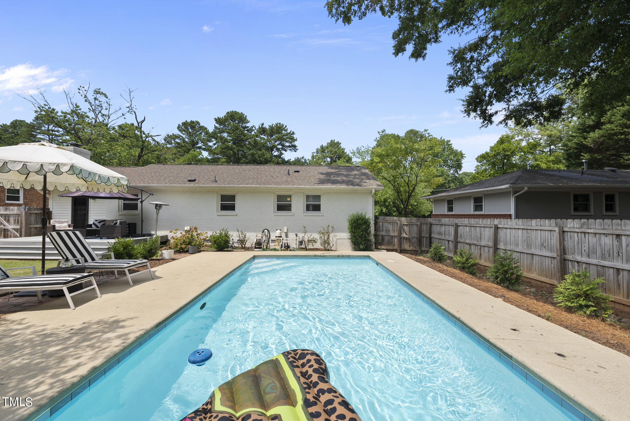 512 East Millbrook Road Raleigh, NC 27609 - Photo 22 of 29 a view of a house with backyard and sitting area