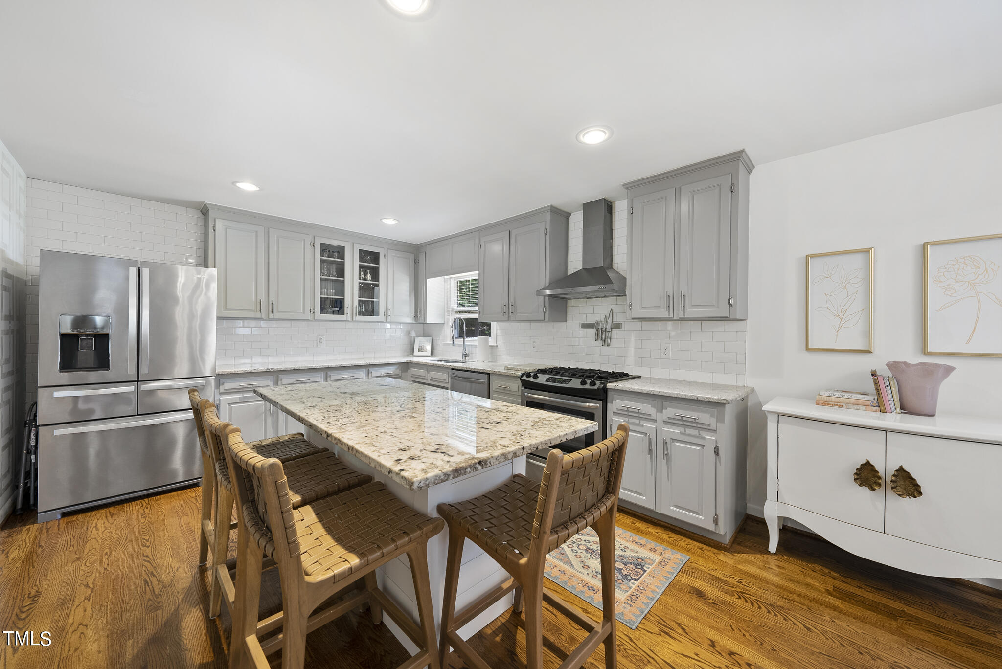 512 East Millbrook Road Raleigh, NC 27609 - Photo 5 of 29 a kitchen with stainless steel appliances granite countertop a table chairs sink refrigerator and microwave