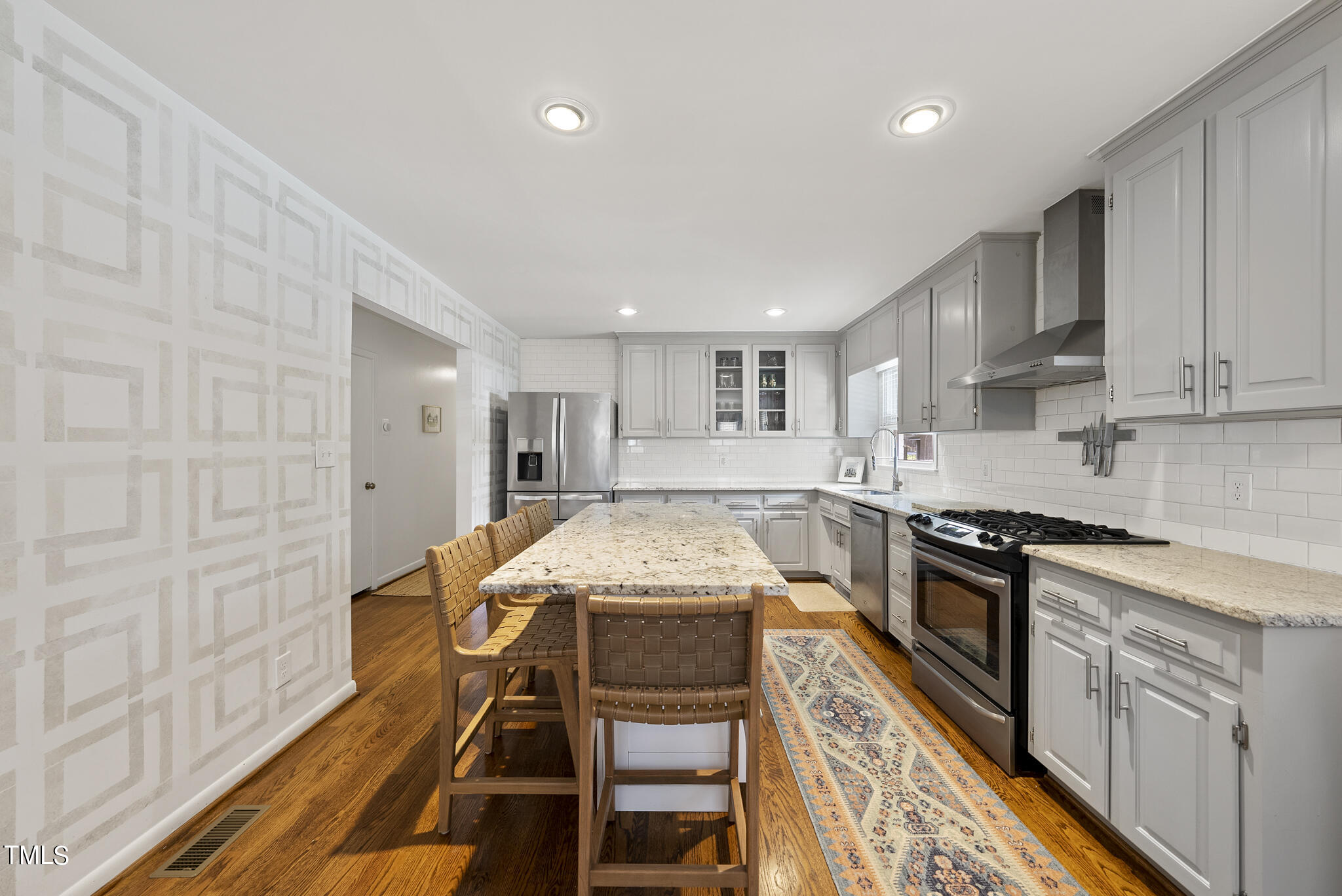 512 East Millbrook Road Raleigh, NC 27609 - Photo 6 of 29 a kitchen with stainless steel appliances granite countertop a stove a sink dishwasher and a refrigerator with wooden floor