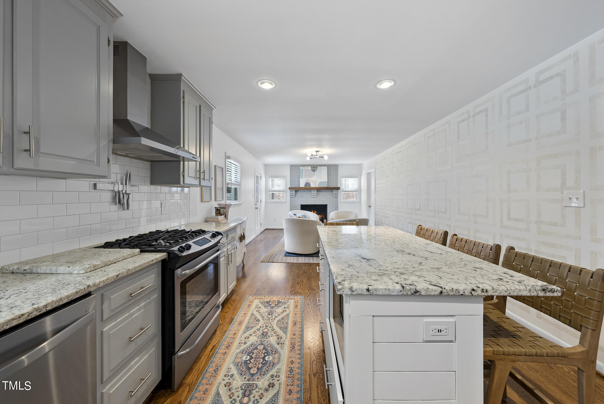 512 East Millbrook Road Raleigh, NC 27609 - Photo 7 of 29 a kitchen with granite countertop stainless steel appliances and wooden cabinets
