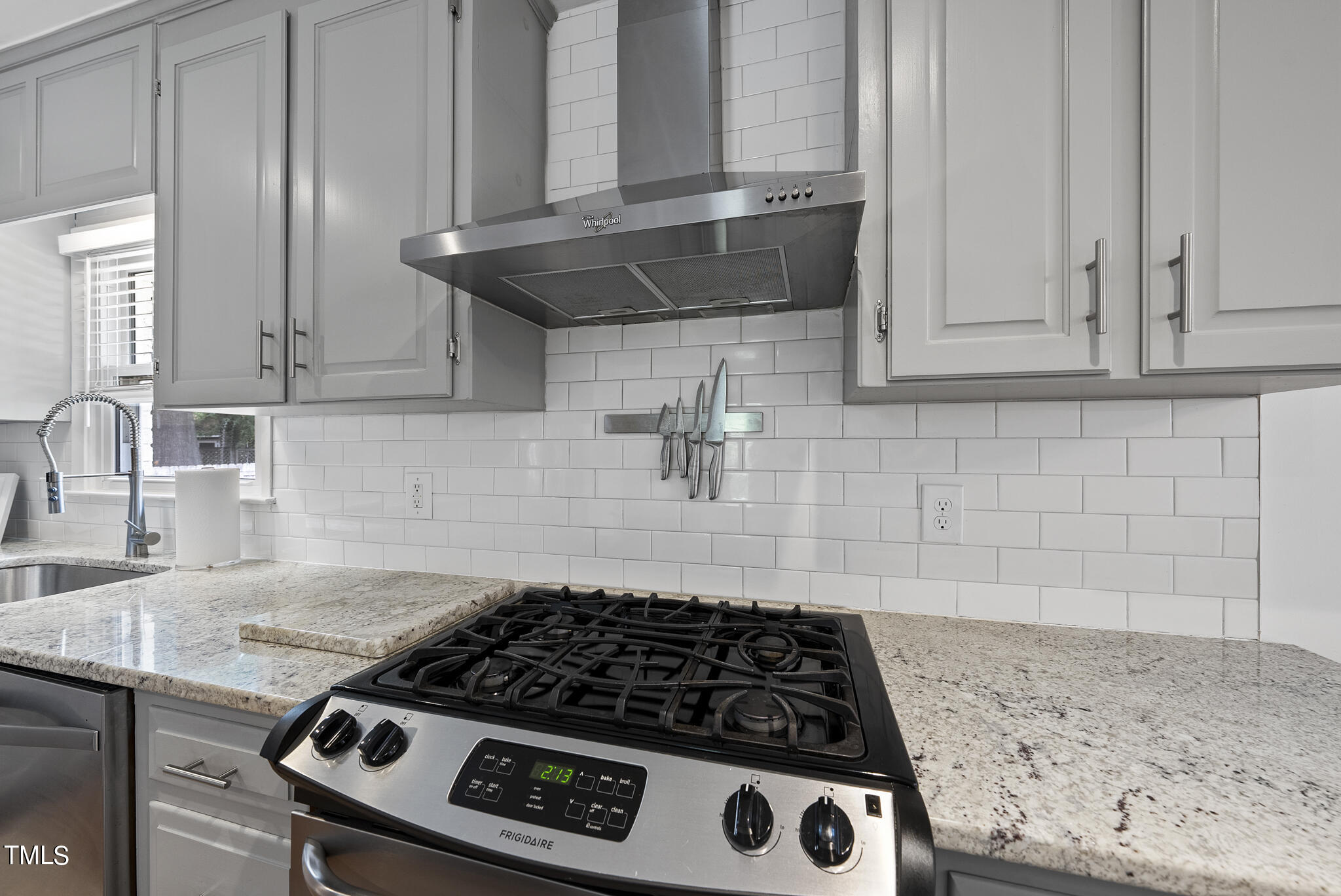 512 East Millbrook Road Raleigh, NC 27609 - Photo 8 of 29 a kitchen with granite countertop a stove and a sink