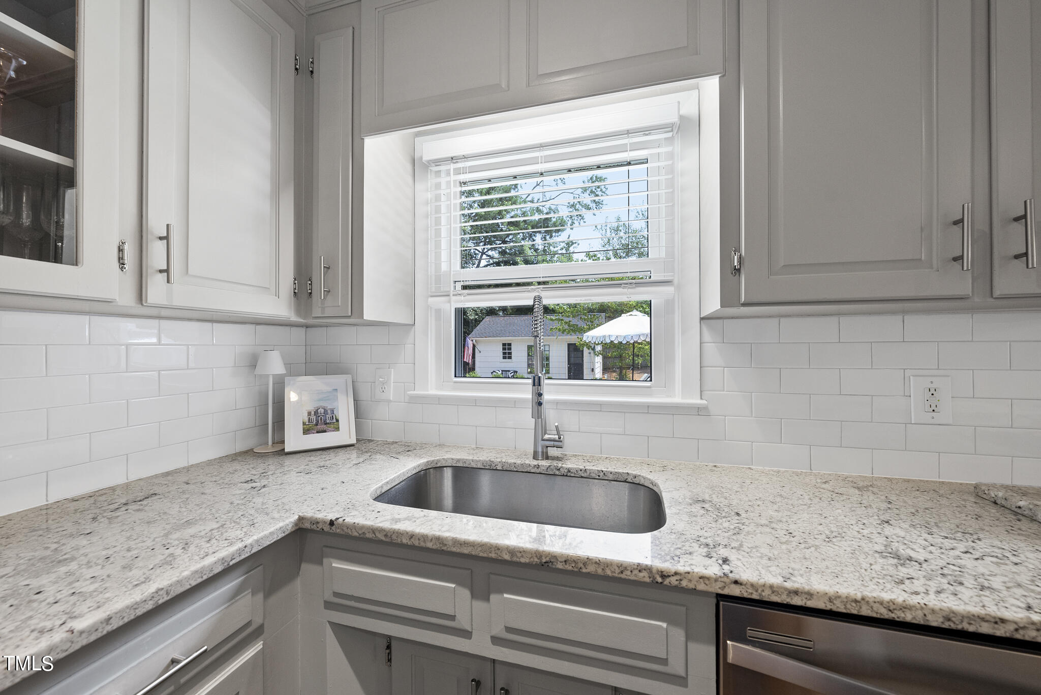 512 East Millbrook Road Raleigh, NC 27609 - Photo 9 of 29 a kitchen with granite countertop a sink and a window