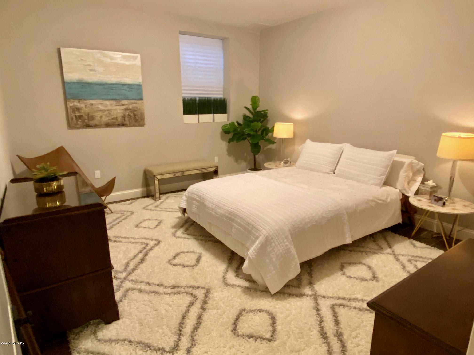 1 Club Road Riverside, CT 06878 - Photo 32 of 37 a bedroom with a bed and wooden floor