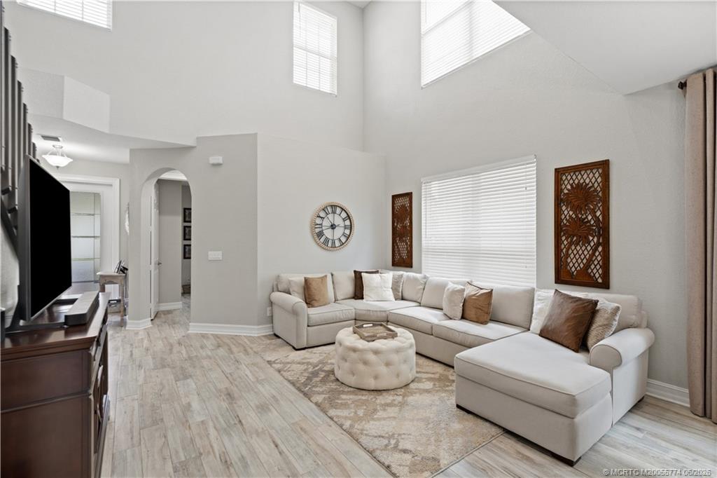 1268 Southeast Kirk Street Stuart, FL 34997 - Photo 19 of 63 a living room with furniture wooden floor and a flat screen tv