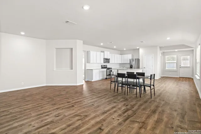 a view of a dining room with furniture and wooden floor