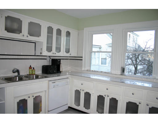 19 Sunset Road, Unit 19 Watertown, MA 02472 - Photo 7 of 17 a kitchen with stainless steel appliances granite countertop a sink and a white cabinets