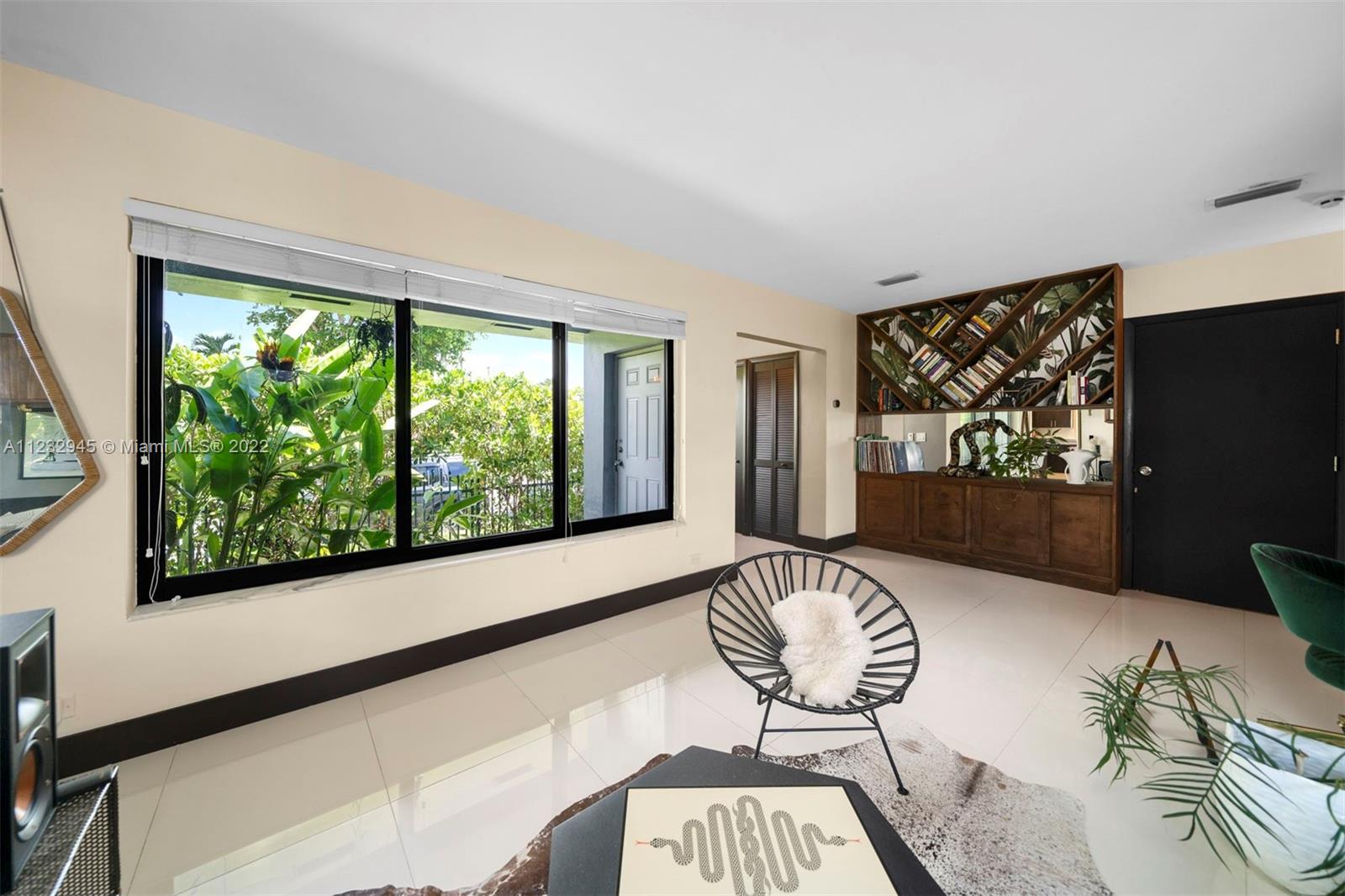 1598 Normandy Drive Miami Beach, FL 33141 - Photo 12 of 40 a living room with furniture and a flat screen tv