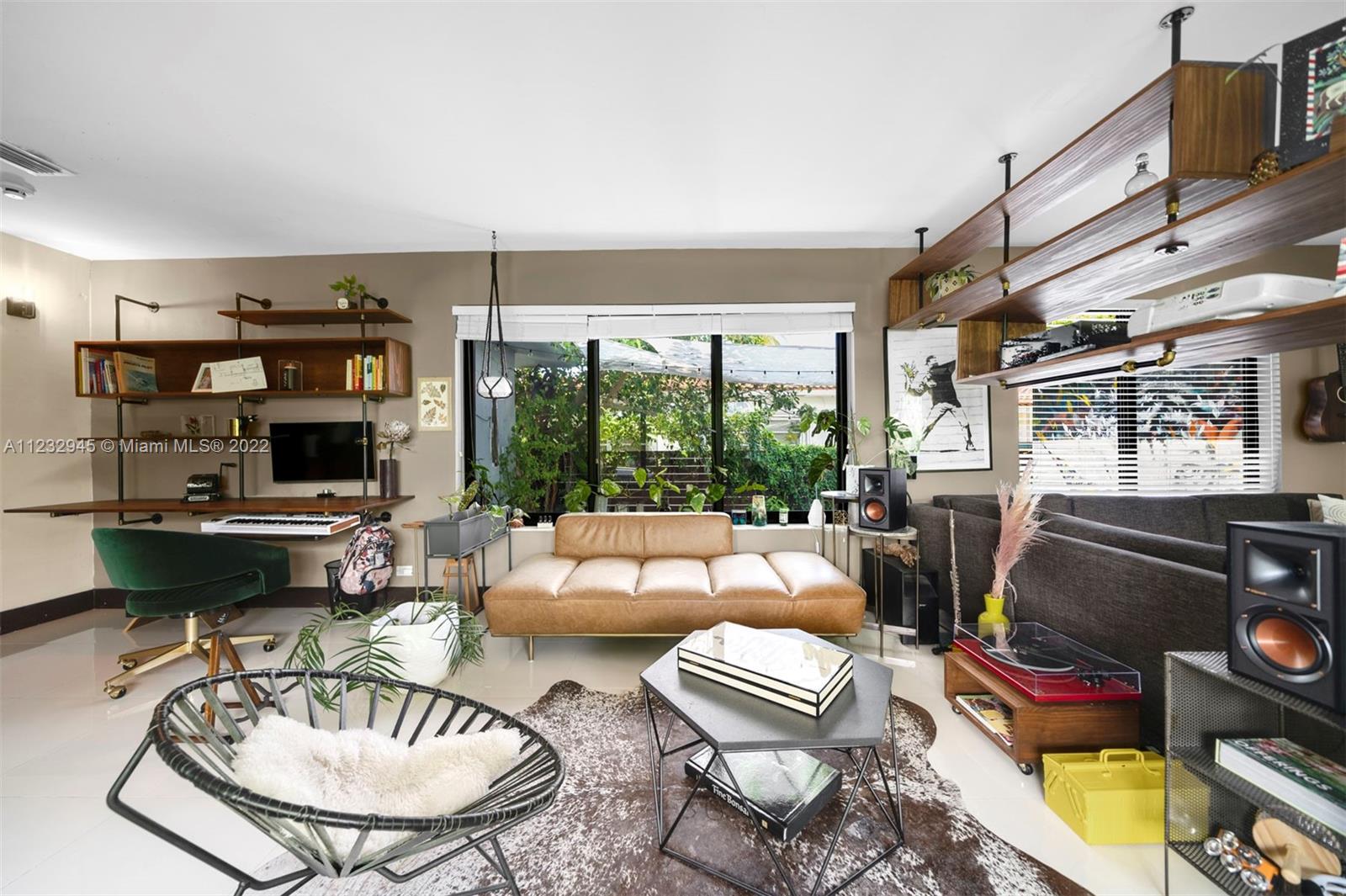 1598 Normandy Drive Miami Beach, FL 33141 - Photo 13 of 40 a living room with furniture fireplace and a large window