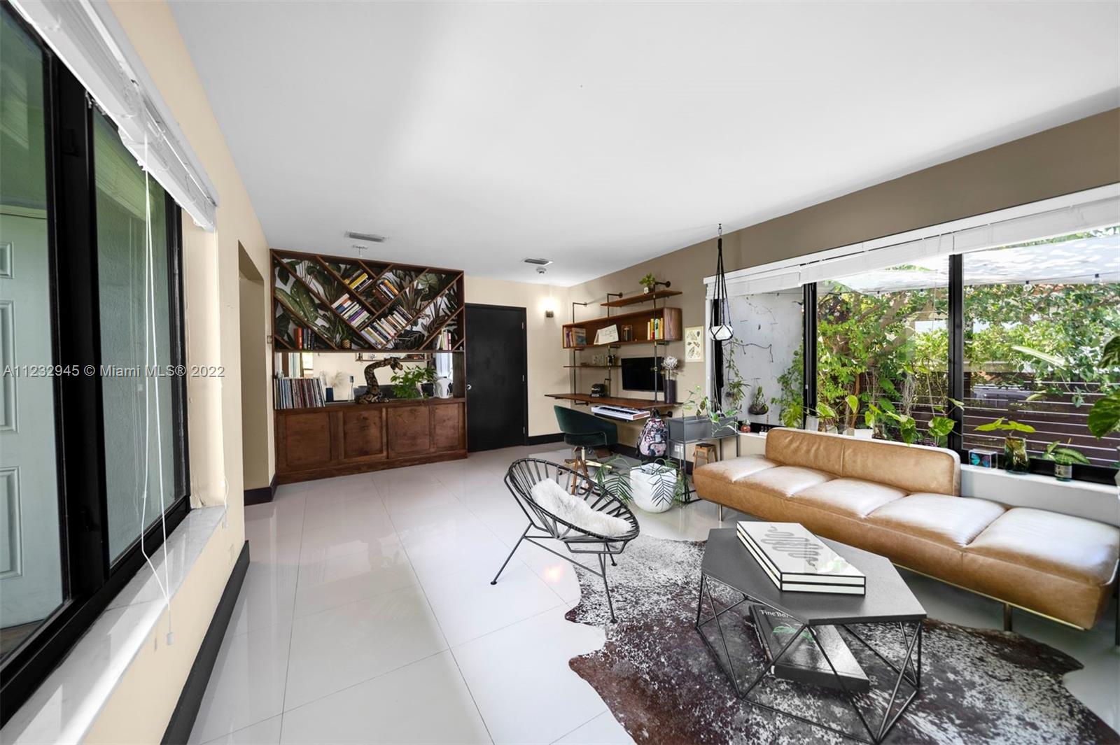 1598 Normandy Drive Miami Beach, FL 33141 - Photo 14 of 40 a living room with furniture and a large window