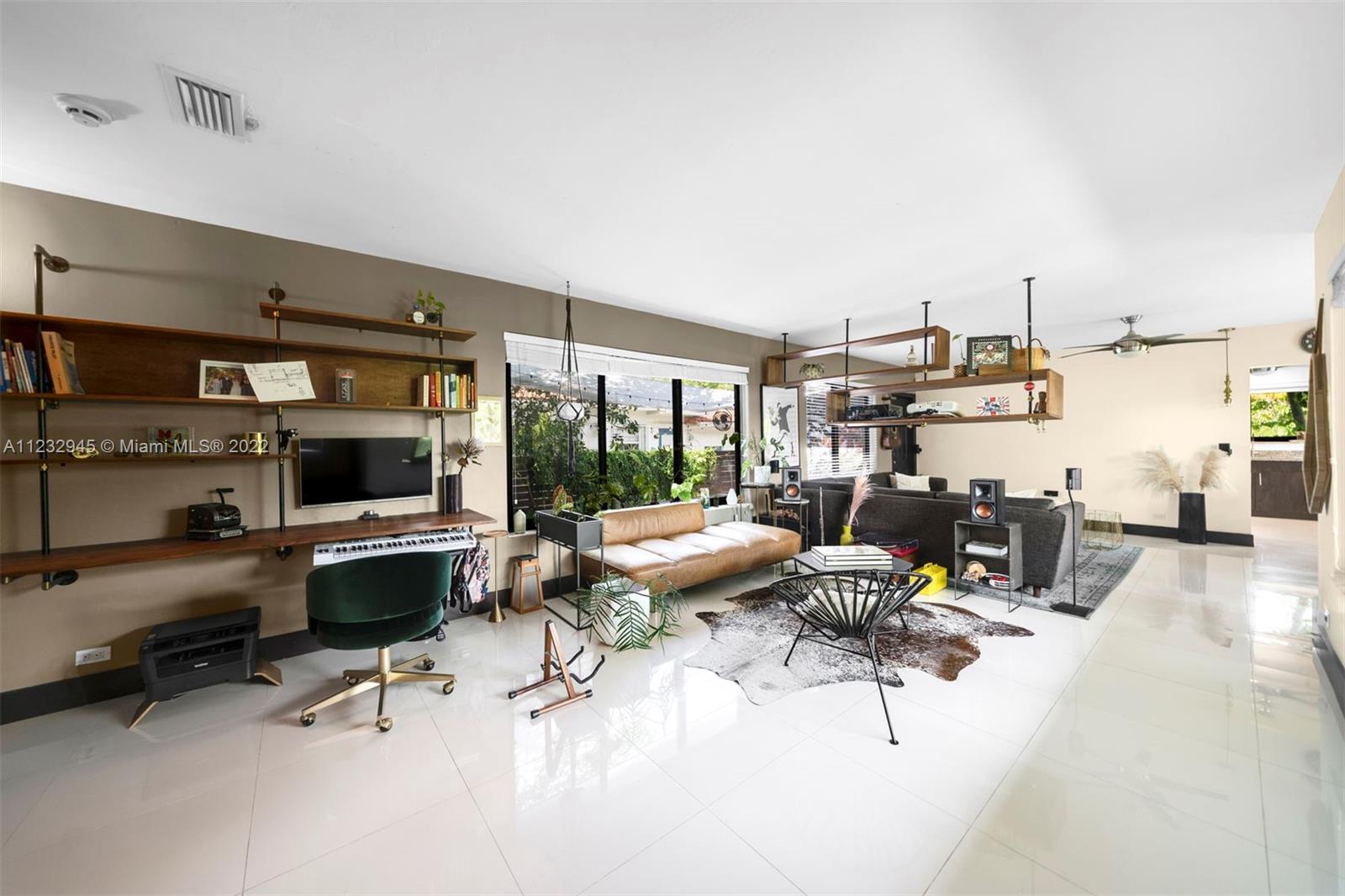 1598 Normandy Drive Miami Beach, FL 33141 - Photo 15 of 40 a living room with furniture and a flat screen tv
