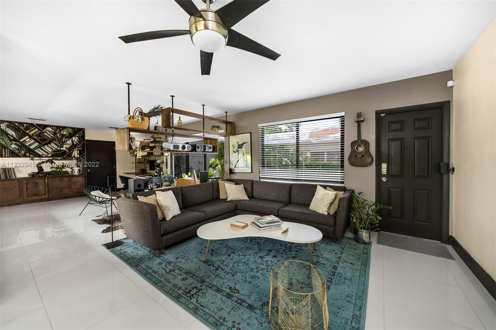 1598 Normandy Drive Miami Beach, FL 33141 - Photo 16 of 40 a living room with furniture and a large window