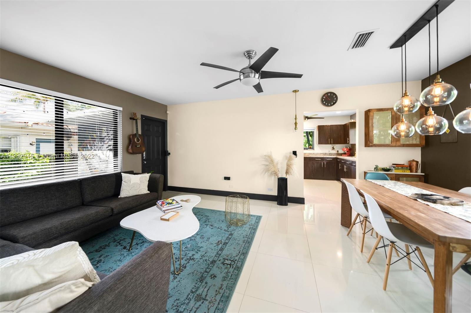 1598 Normandy Drive Miami Beach, FL 33141 - Photo 18 of 40 a living room with furniture and a large window