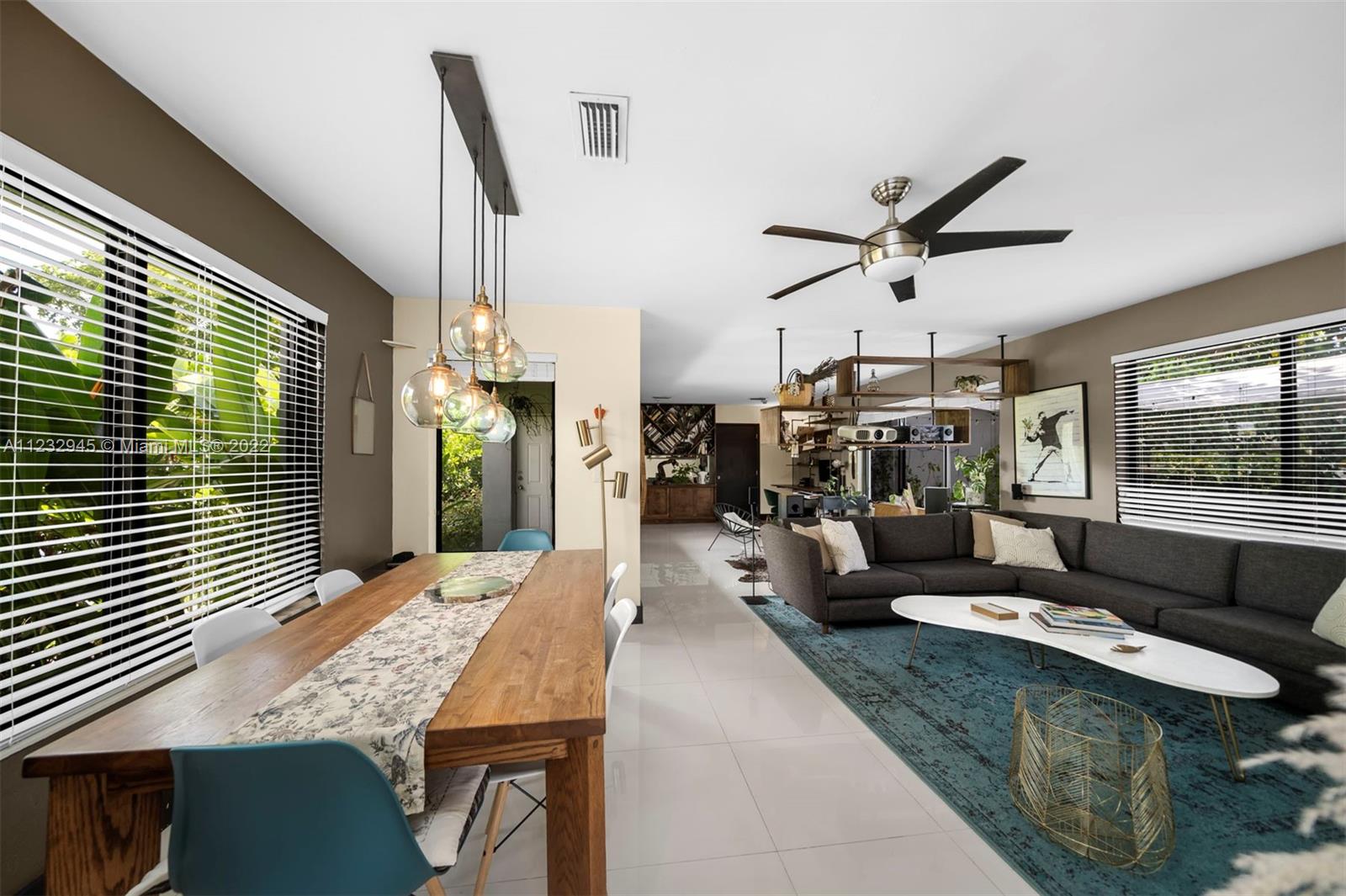 1598 Normandy Drive Miami Beach, FL 33141 - Photo 19 of 40 a living room with furniture and a large window