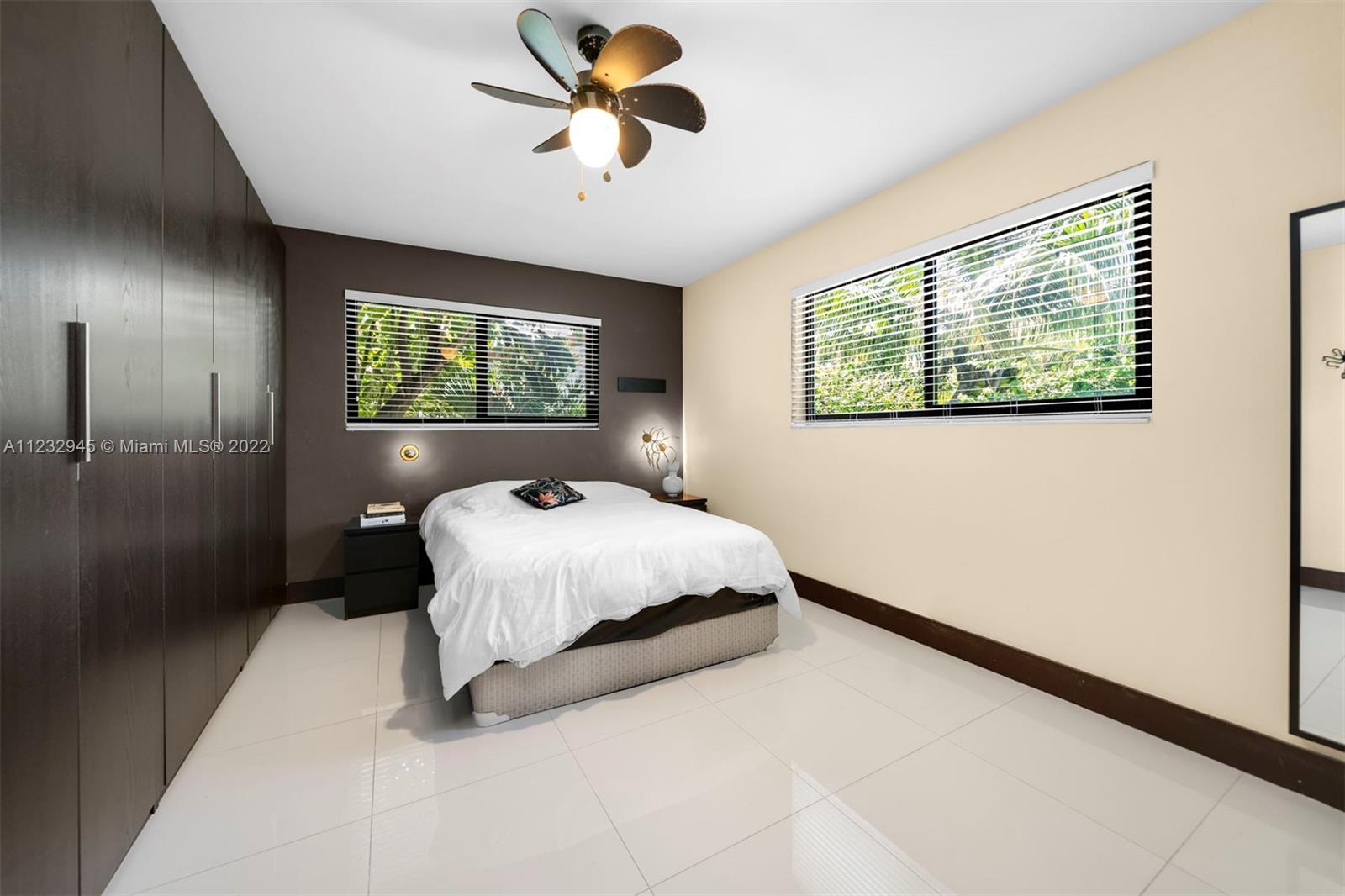 1598 Normandy Drive Miami Beach, FL 33141 - Photo 25 of 40 a bed sitting in a bedroom next to a window