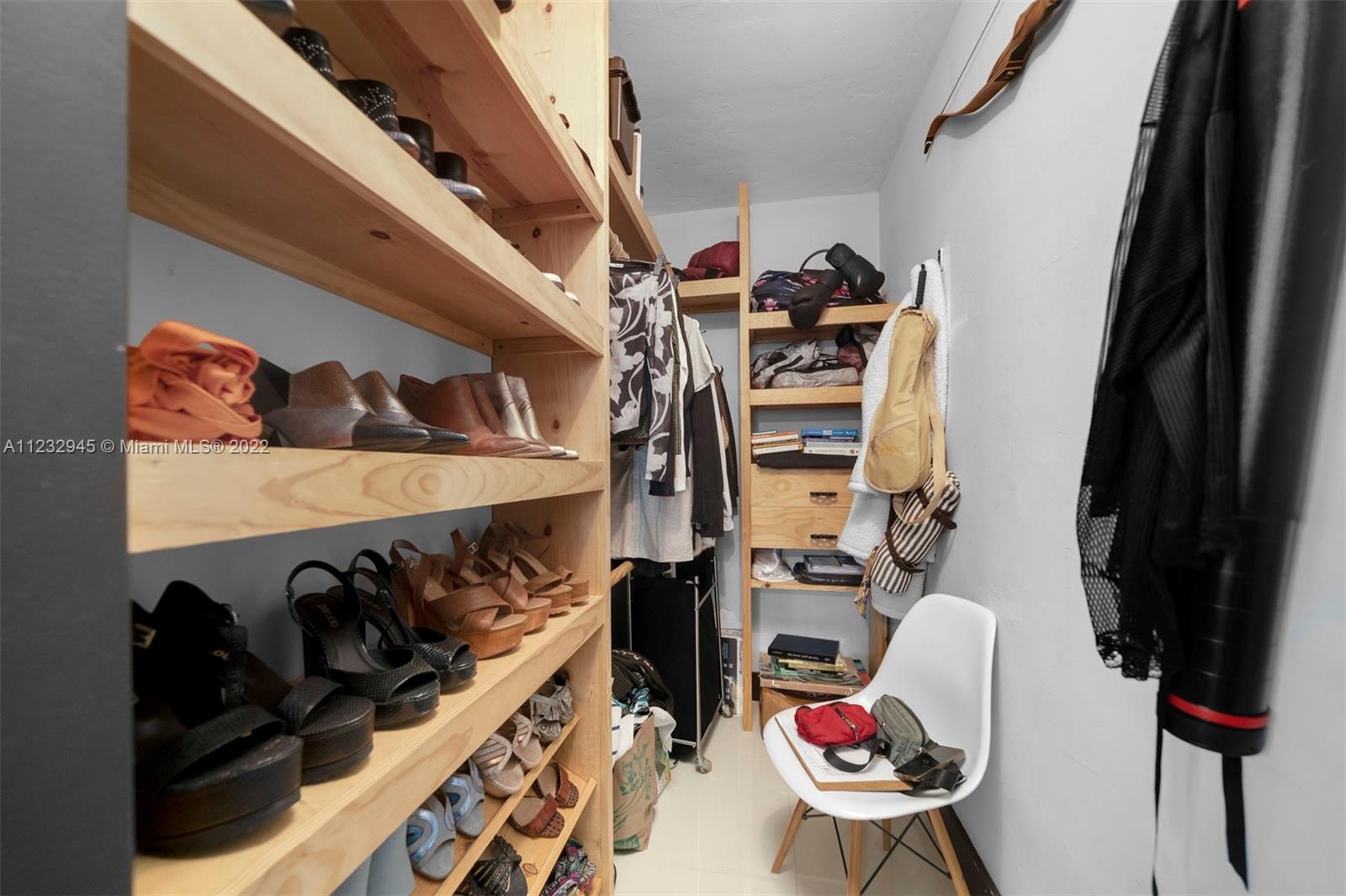 1598 Normandy Drive Miami Beach, FL 33141 - Photo 26 of 40 a view of walk in closet with clothes and shoes