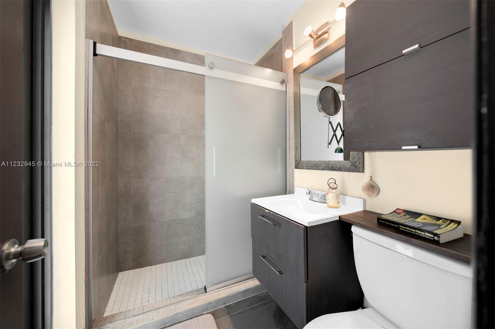 1598 Normandy Drive Miami Beach, FL 33141 - Photo 27 of 40 a bathroom with a sink toilet and shower