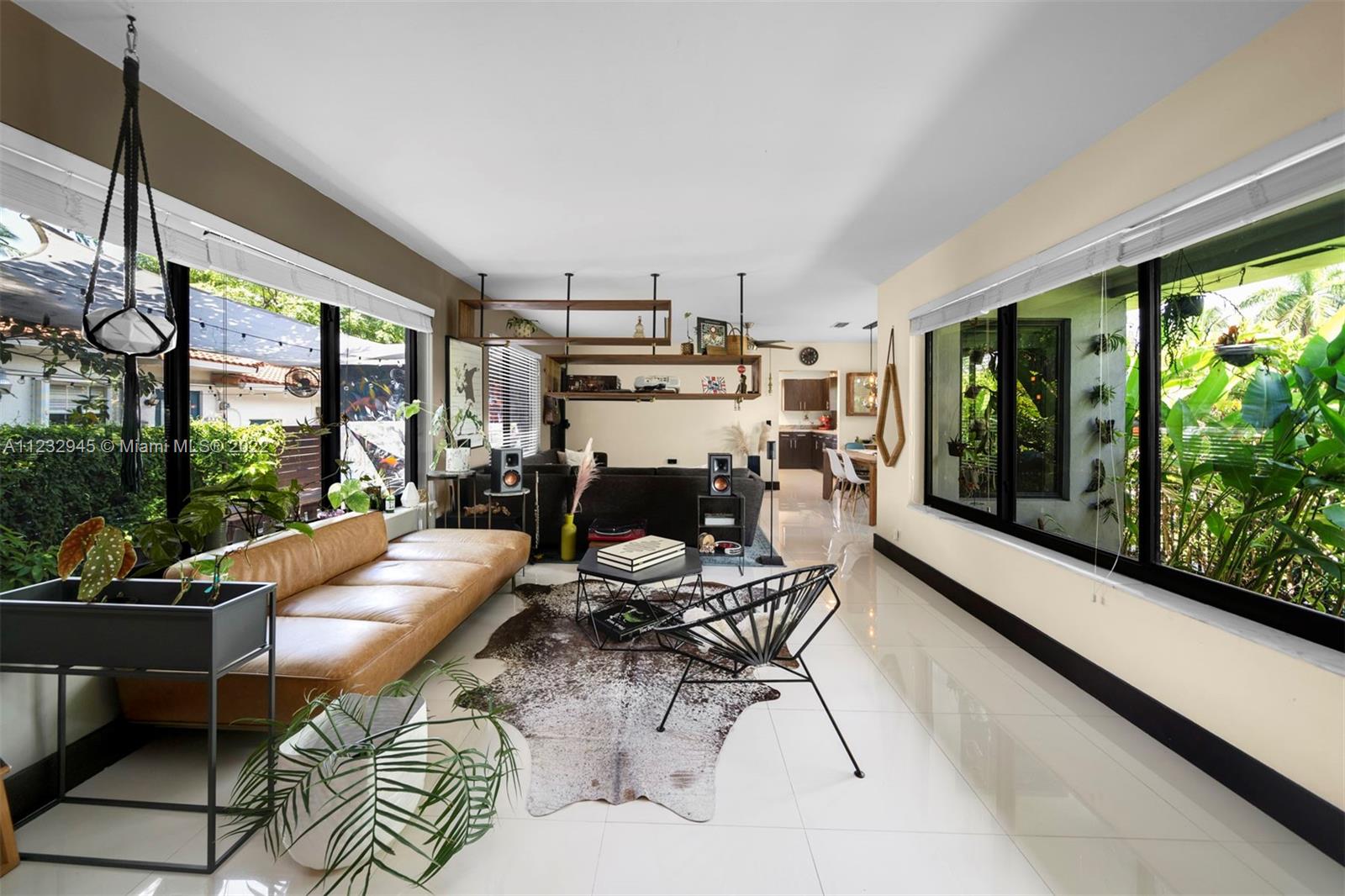 1598 Normandy Drive Miami Beach, FL 33141 - Photo 3 of 40 a living room with fireplace furniture and a large window