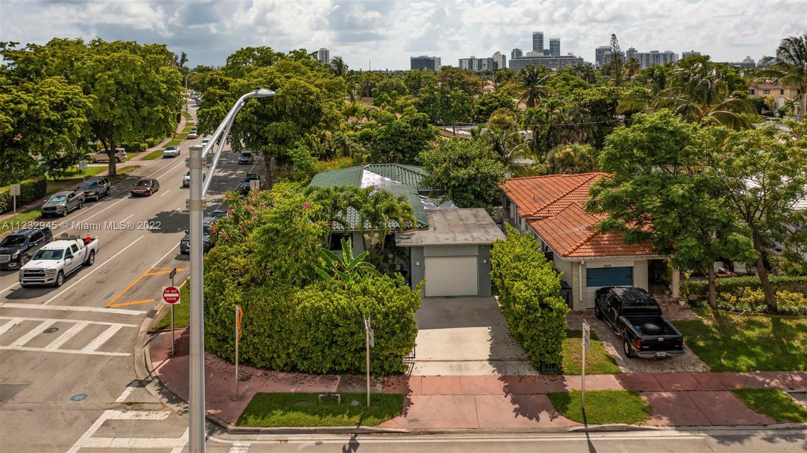 1598 Normandy Drive Miami Beach, FL 33141 - Photo 35 of 40 a front view of a house with a yard and tree