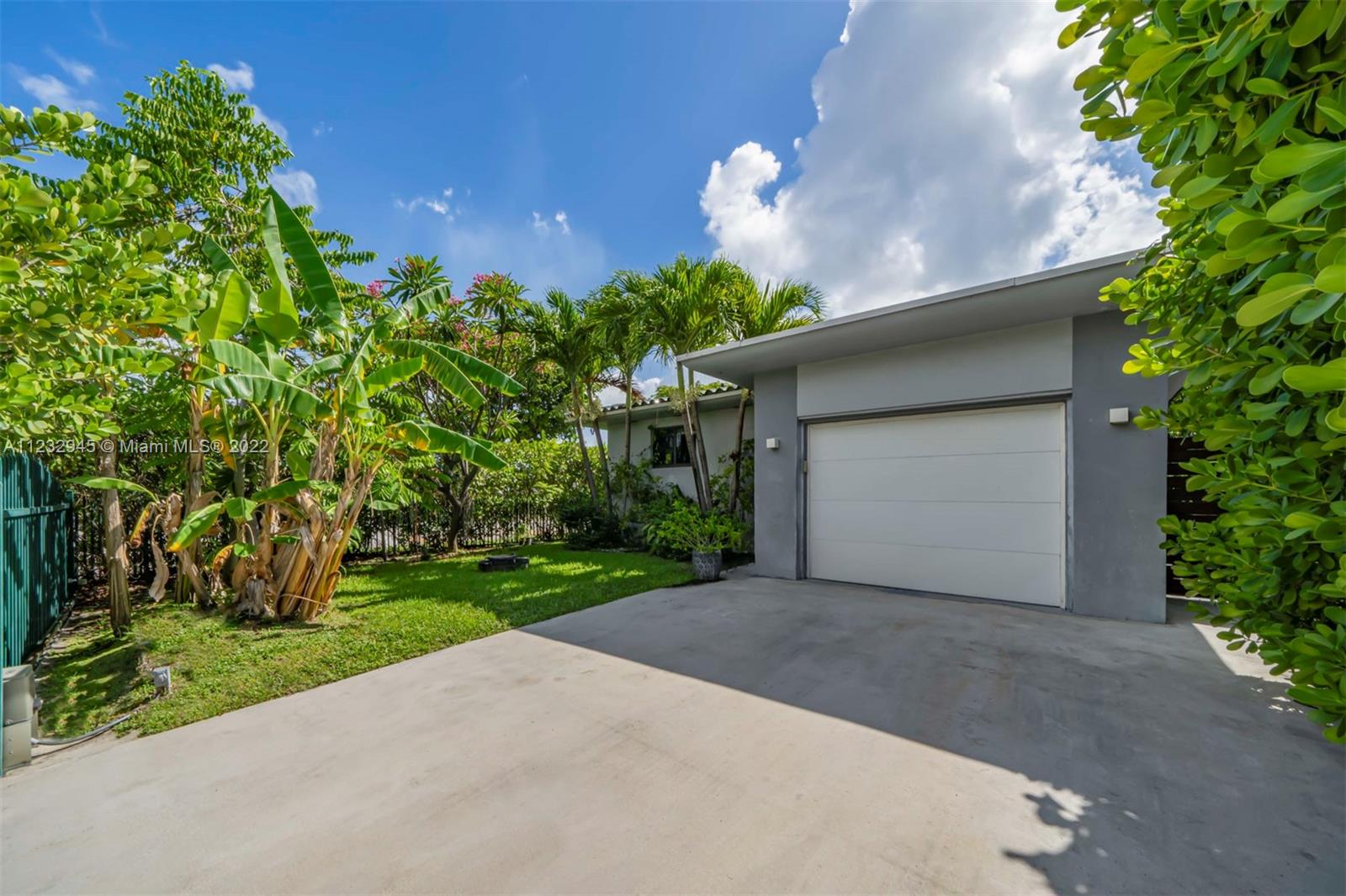 1598 Normandy Drive Miami Beach, FL 33141 - Photo 6 of 40 a backyard of a house with plants and large tree