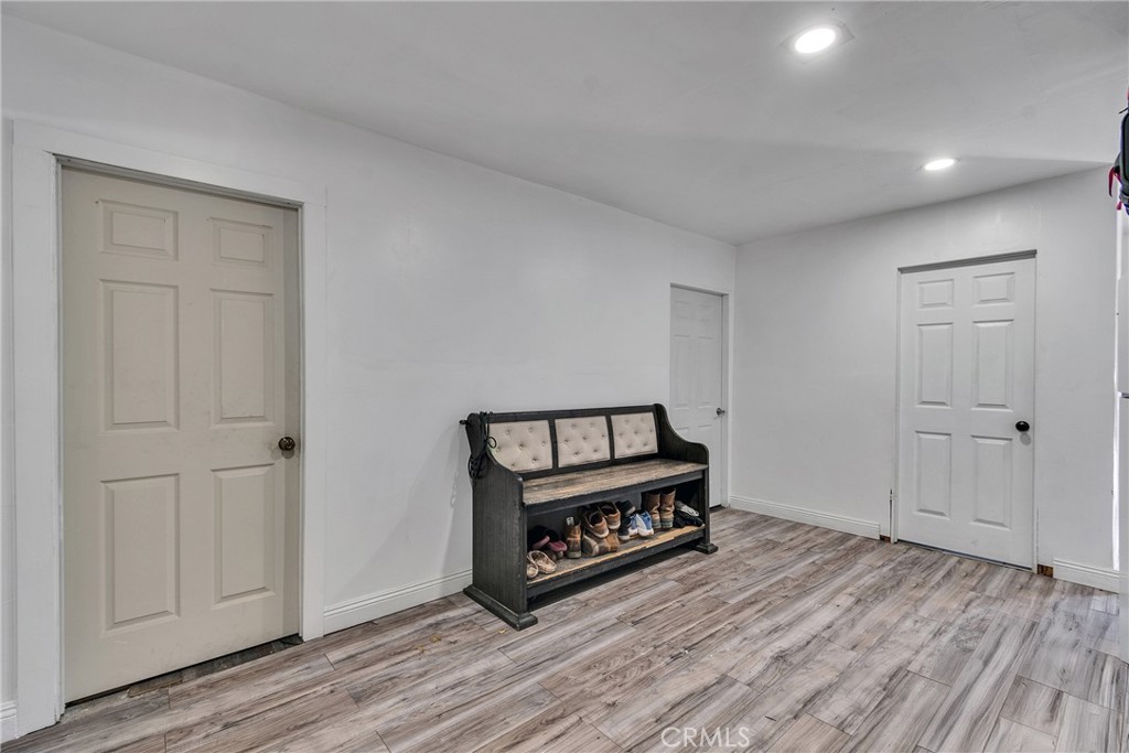 5121 Sierra Street Riverside, CA 92504 - Photo 33 of 34 a view of a hallway with wooden floor and white cabinet