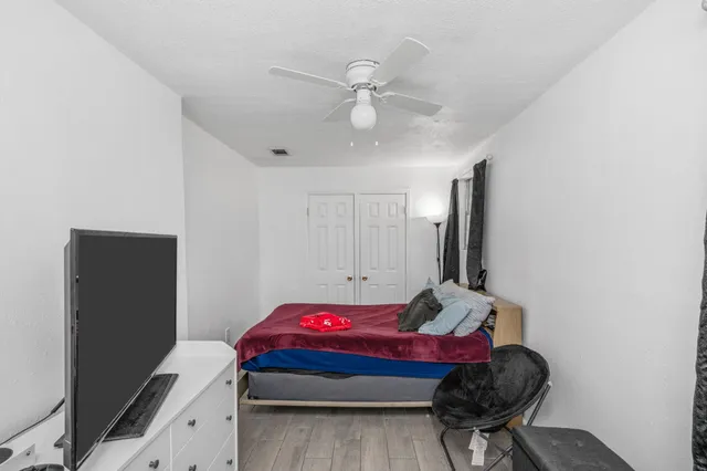 a bedroom with a bed and a chandelier